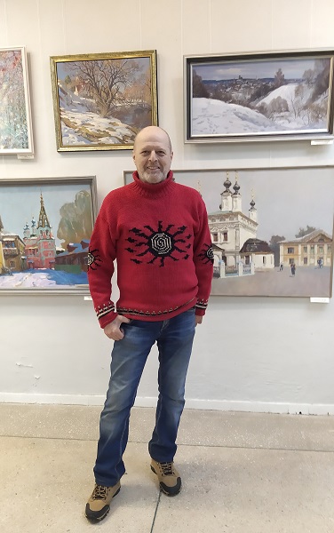 Лауреат выставки-конкурса Евгений Пухов на фоне своих работ